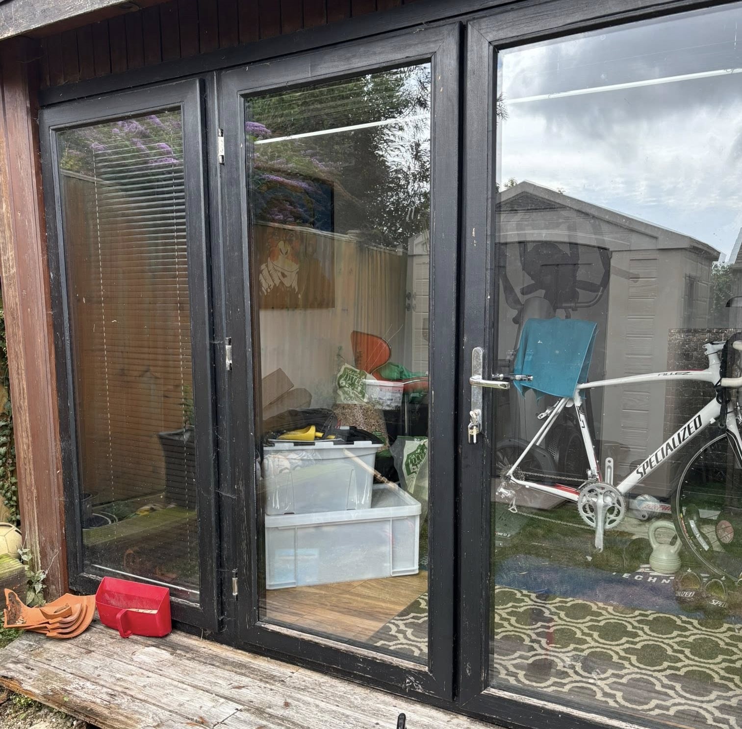 Door glass pane reflecting the skies outside while showing the inside of the property