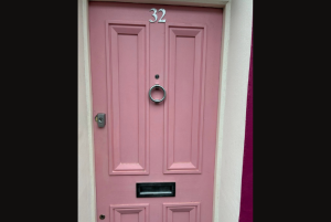 Pink wooden door with door lock and furnishings by ASL Locksmiths Brighton